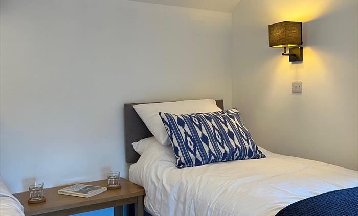 The second bedroom includes two single beds